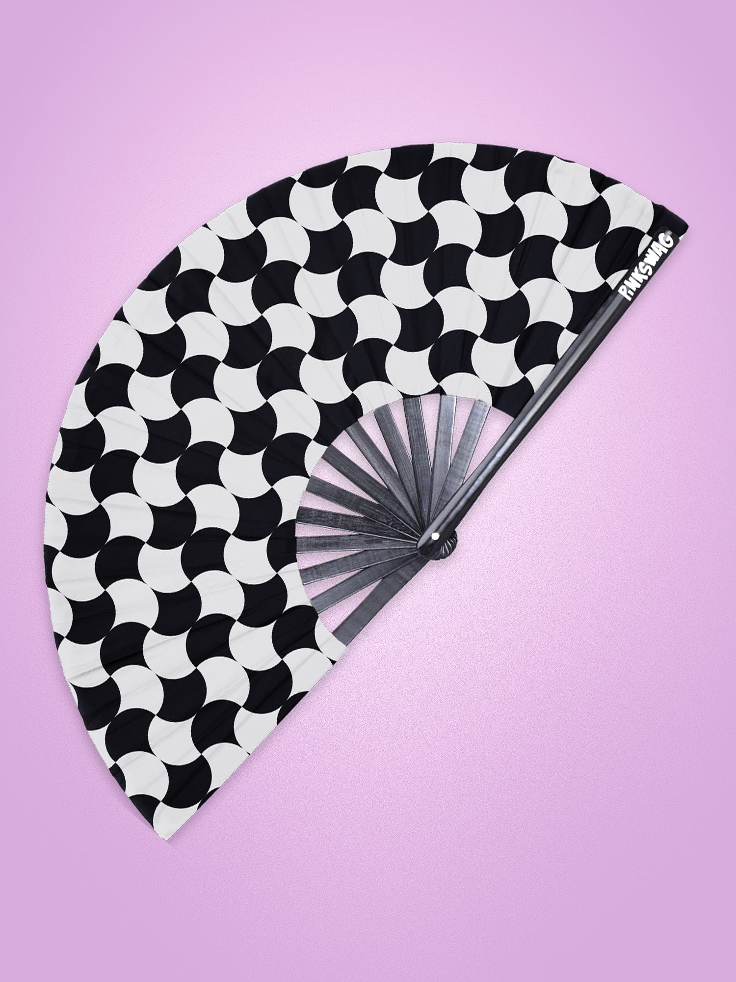 Black and white patterned fan on a pink background