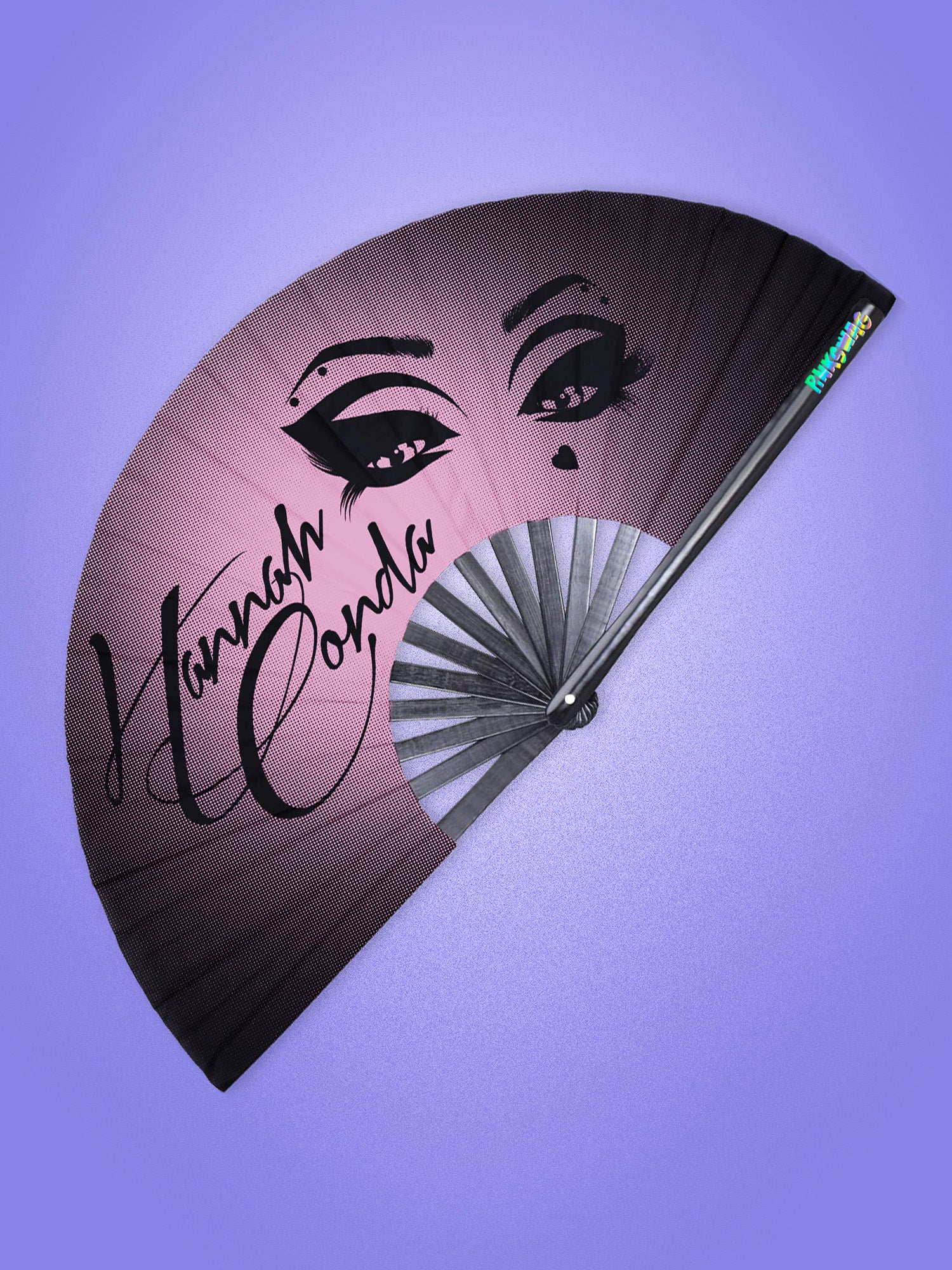 Handheld fan with artistic face design and 'Hannah Conda' text on a purple background